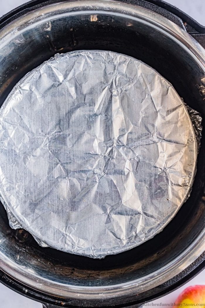 Foil covering the cream cheese in the Instant Pot.