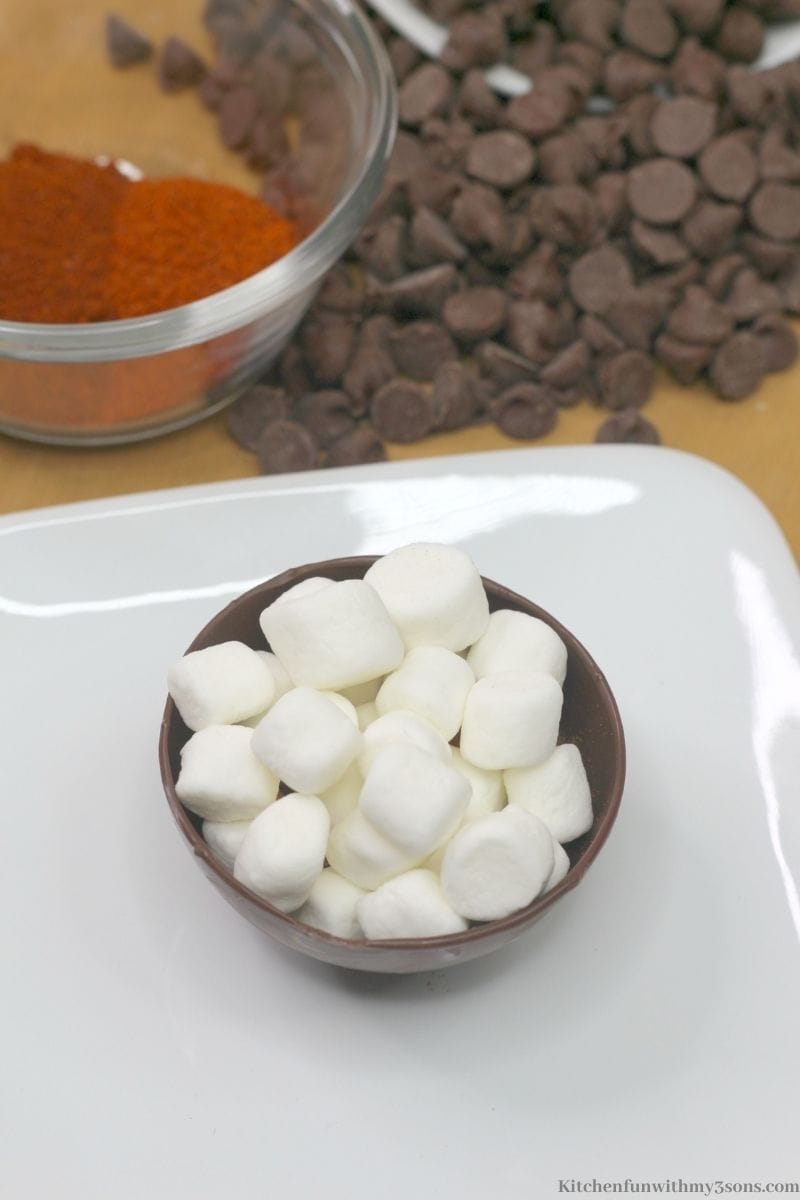 Adding the marshmallows on top of the cocoa mix.