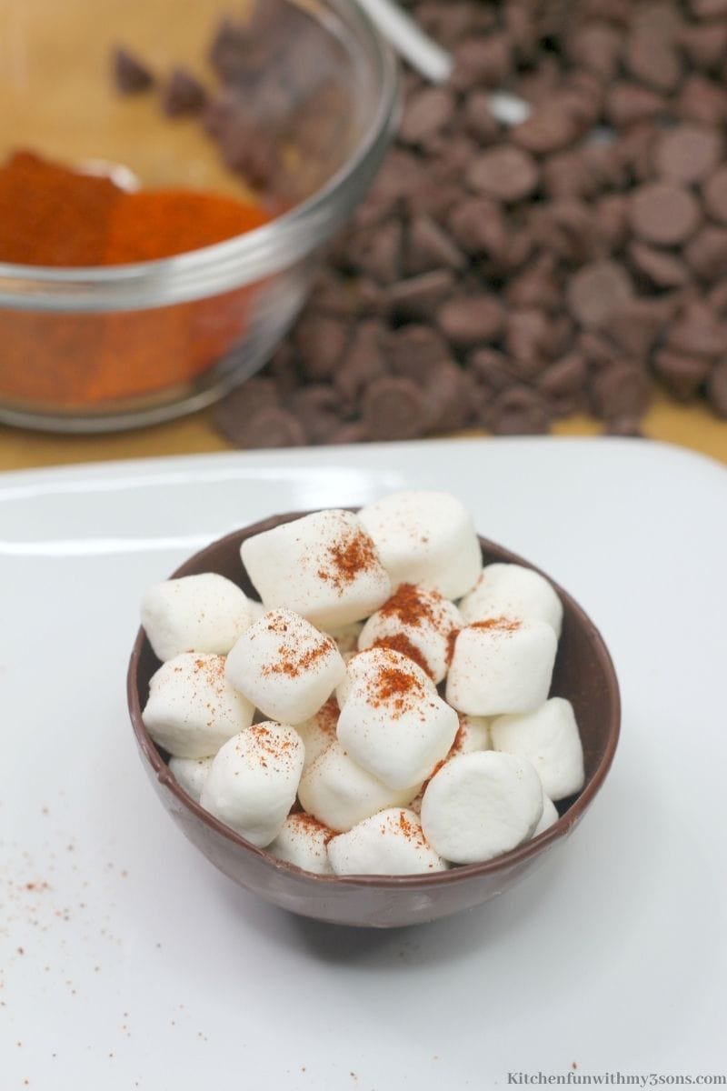 Sprinkling Chili and Cayenne pepper on top of the marshmallows.