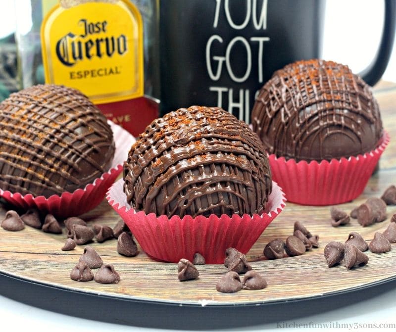 Mexican Hot Cocoa Tequila Bombs on a wooden circular board.