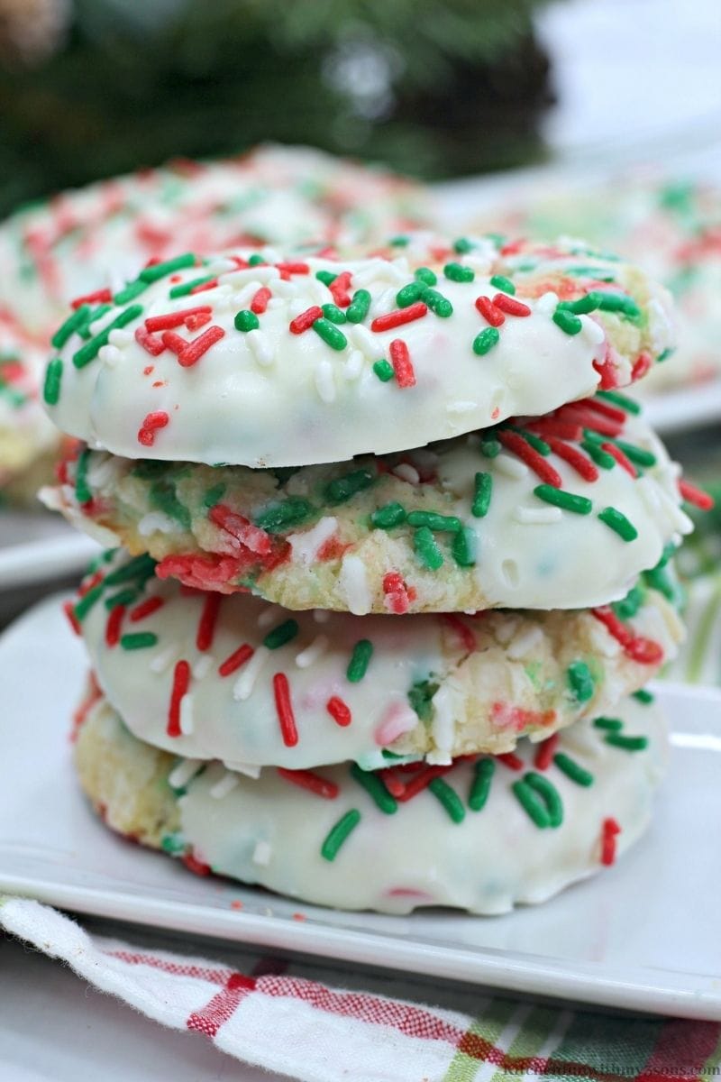 The Best Christmas Gooey Butter Cookies stacked on top of each other.
