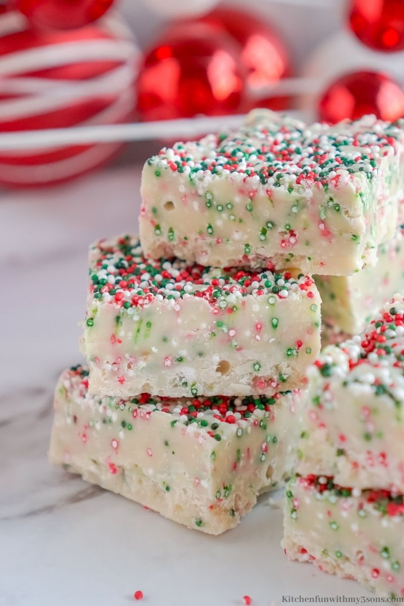 Christmas Cookie Fudge Recipe with red ornaments behind it.