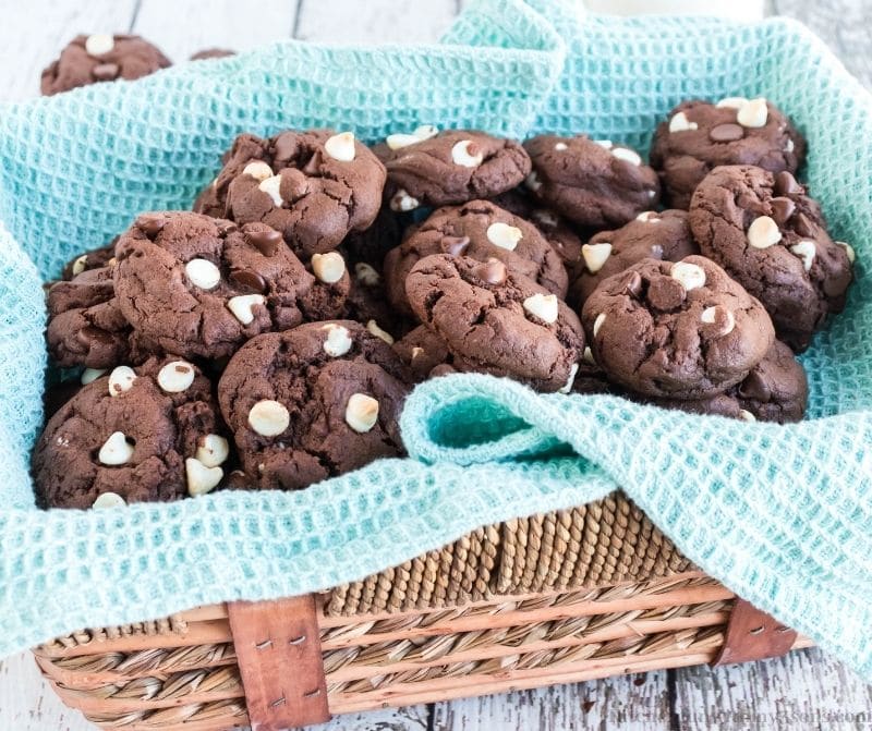 Triple Chocolate Cookies in a basket with a blue blanket.