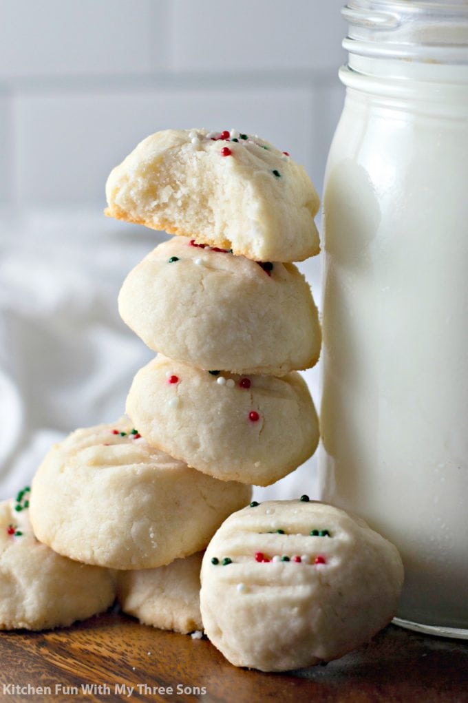 Whipped Shortbread Cookies stacked next to milk