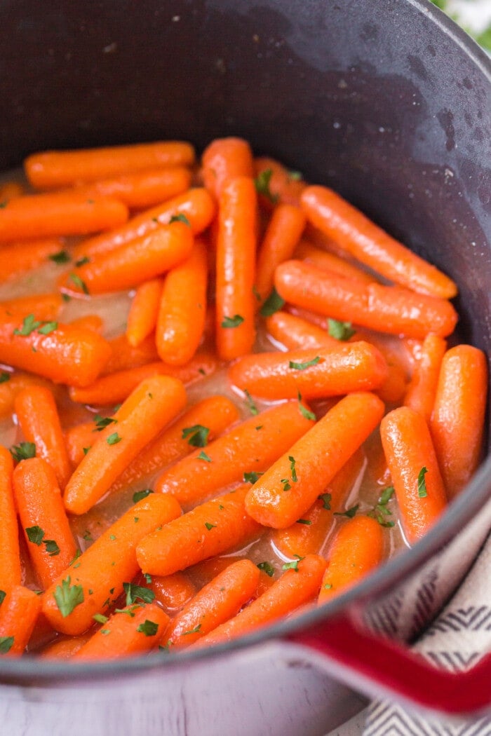 carrots being cooked in the glaze