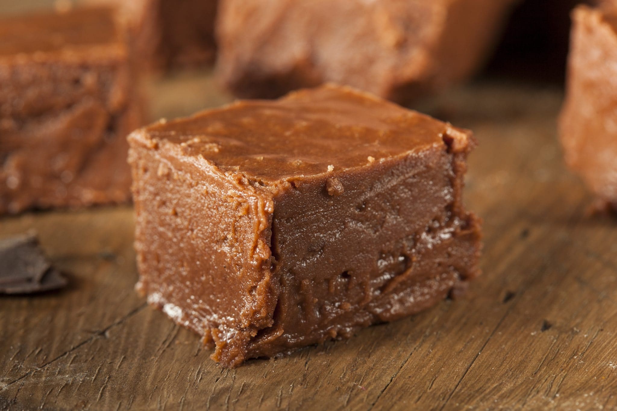 A single square of chocolate fudge on the counter.