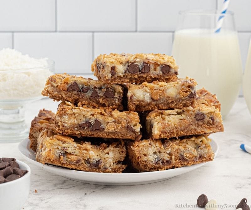 A plate piled with 7 layer magic bars
