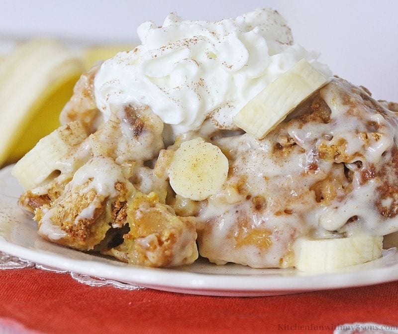 Banana bread pudding on a plate topped with whipped cream
