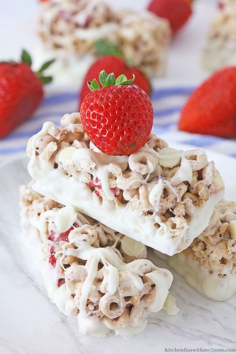 Three of the Berries and Cream Cereal Bar recipe on a plate.