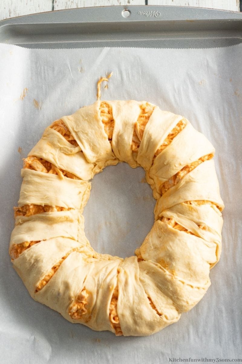 The crescent roll points draped over the filling.