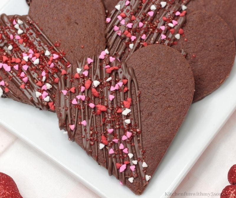 Chocolate Heart Shortbread Cookies with half drizzled chocolate and sprinkles on top.