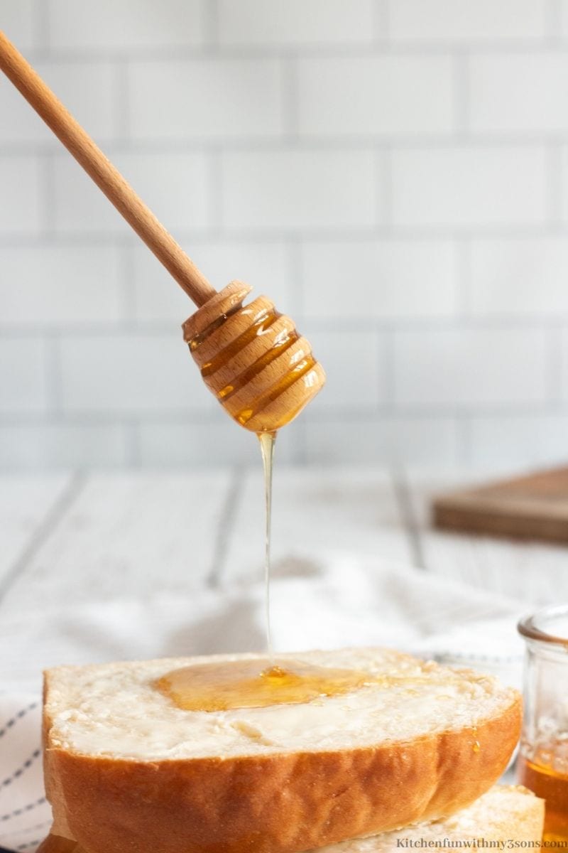 Honey being dripped onto the finished milk bread.