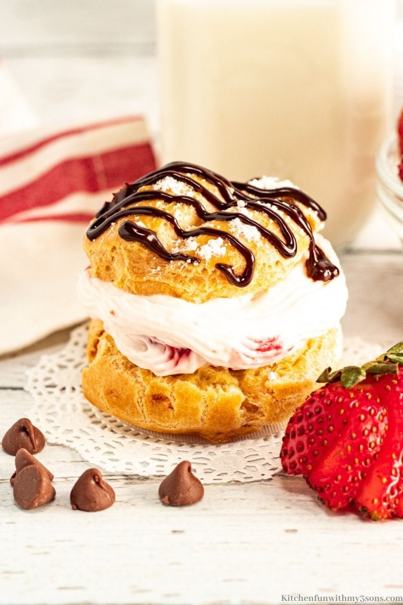 Cream puff with extra chocolate chips and fresh strawberries.