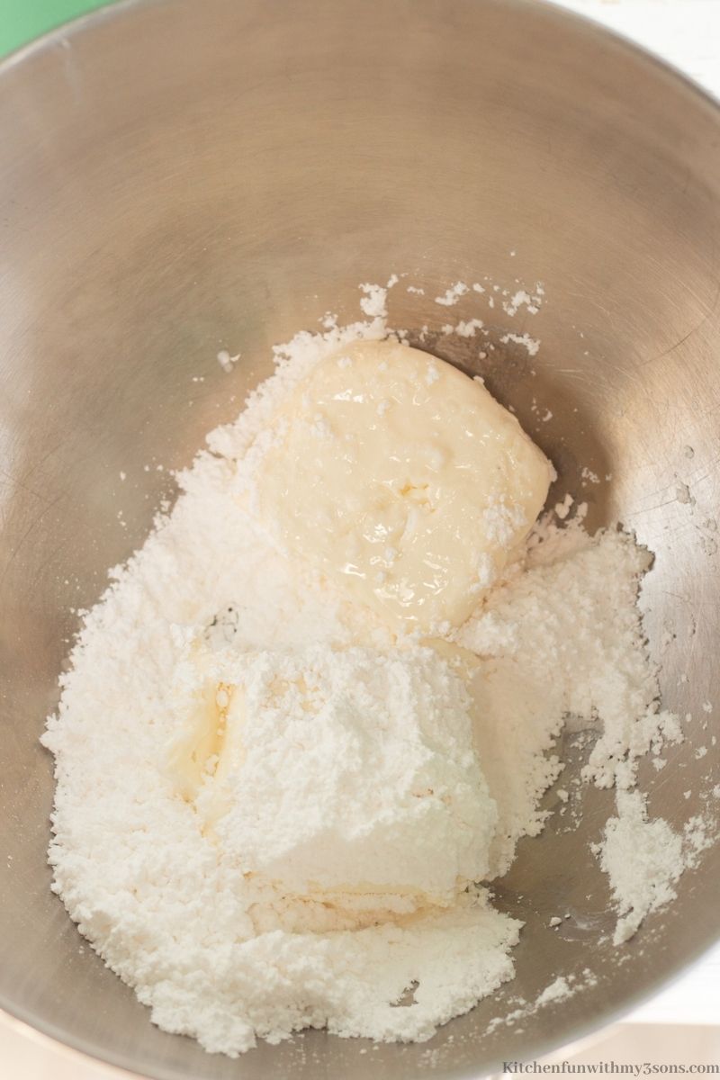 The cream cheese and powdered sugar in an electric mixer.
