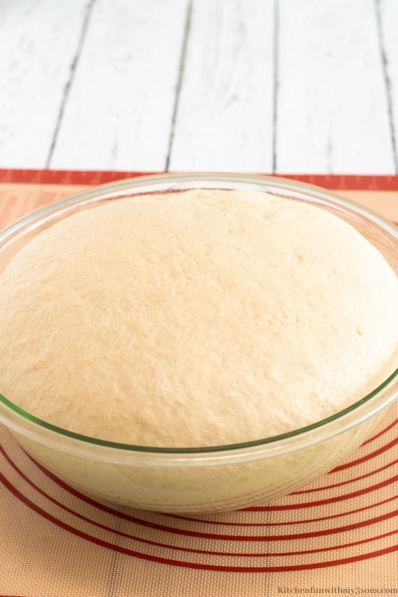 Letting the dough rise and double in size in a large bowl.