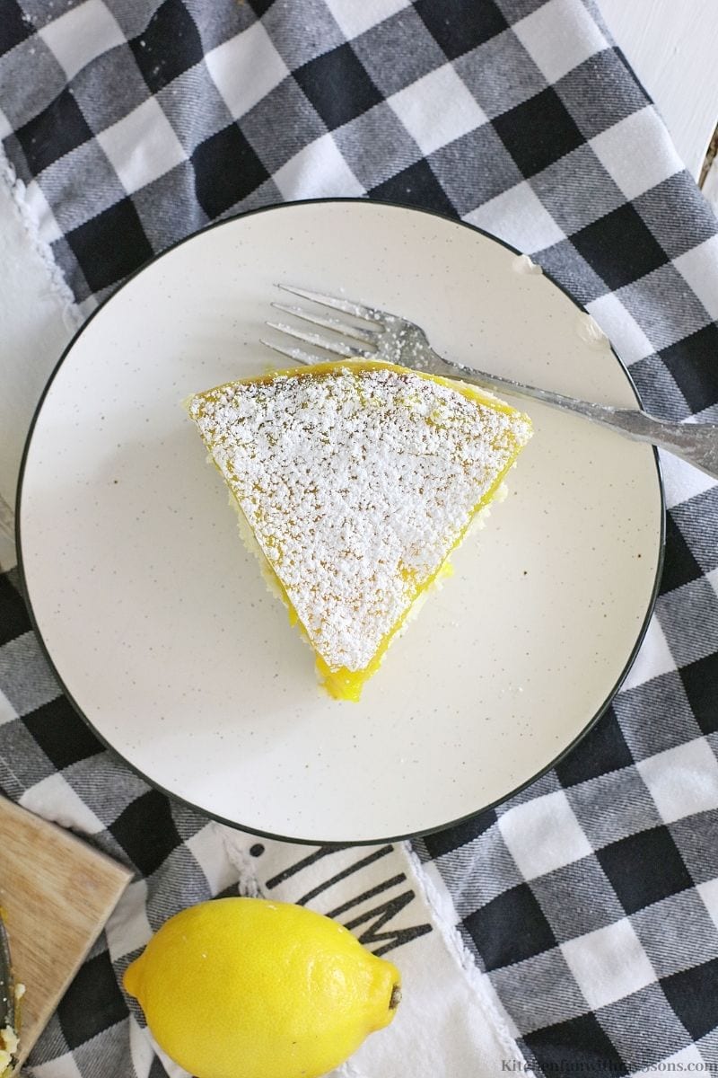 Lemon Bar Cheesecake slice on a plate