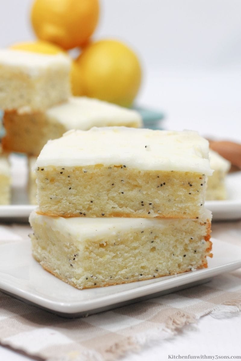 Lemon Poppy Seed Bars on a small square serving plate.