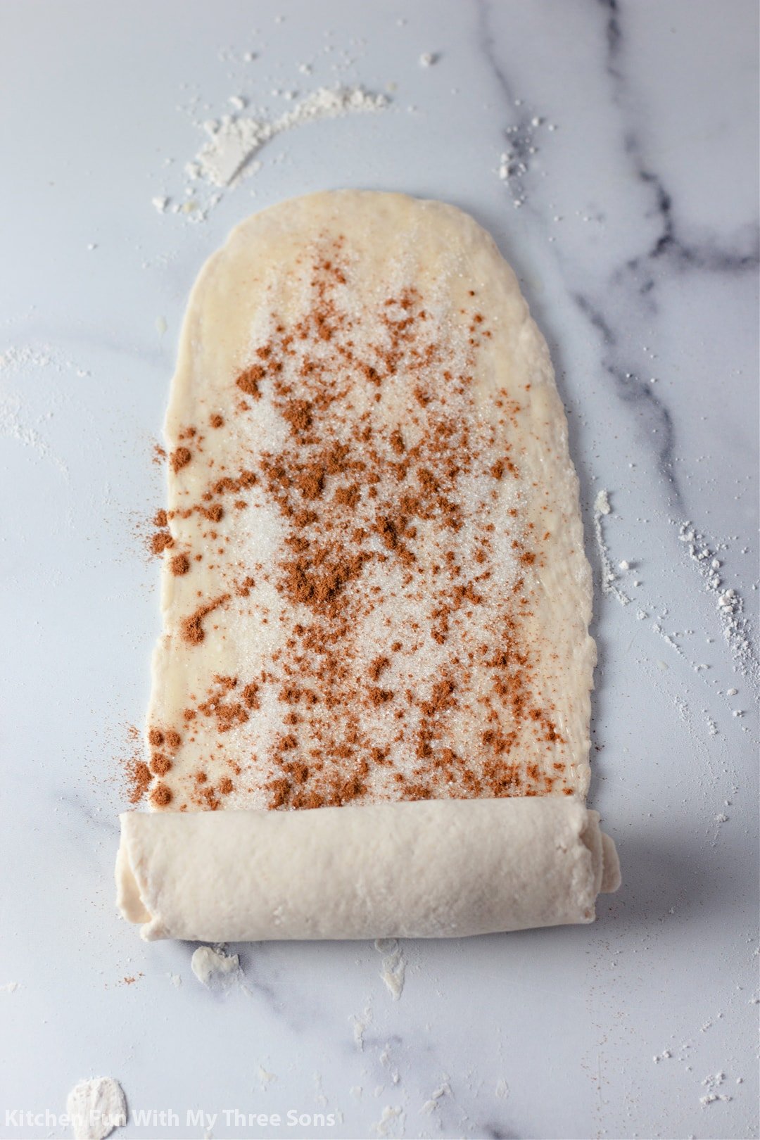rolling up the cinnamon roll dough