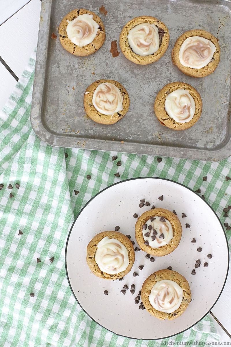 Mini Chocolate Chip Cookie Cheesecakes on a tin sheet pan and platter.