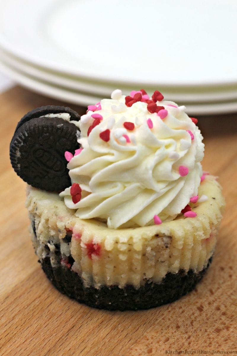 Oreos and sprinkles on top of the cheesecake.