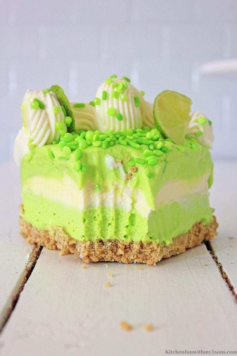 A piece of the no bake key lime cheesecake with a bite taken out of it.
