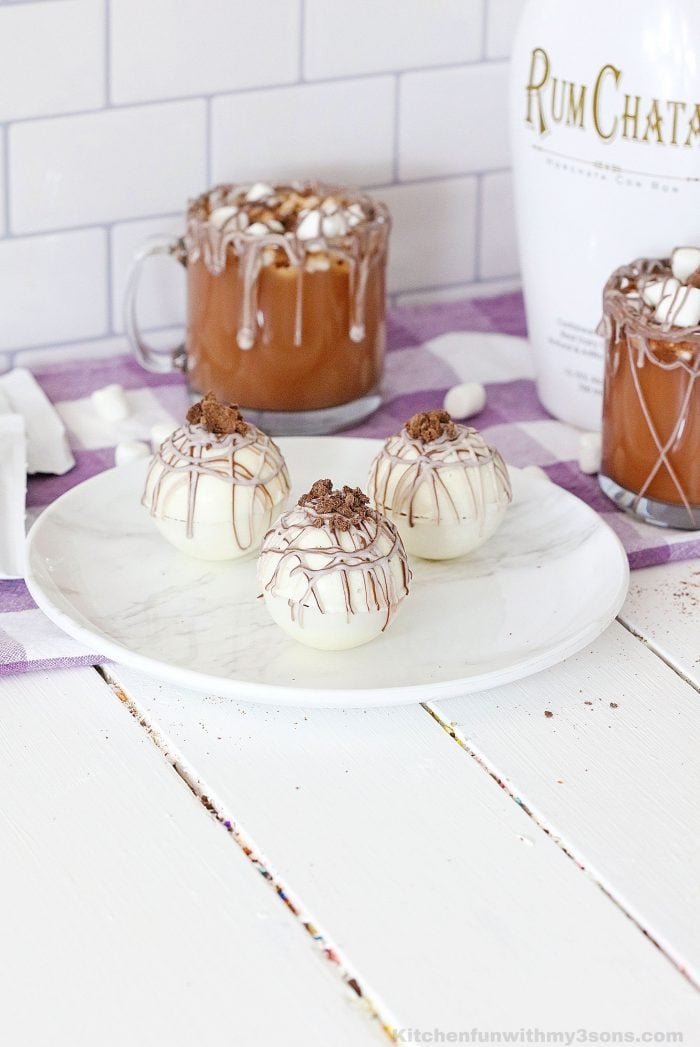 White chocolate hot cocoa bombs on a white plate 