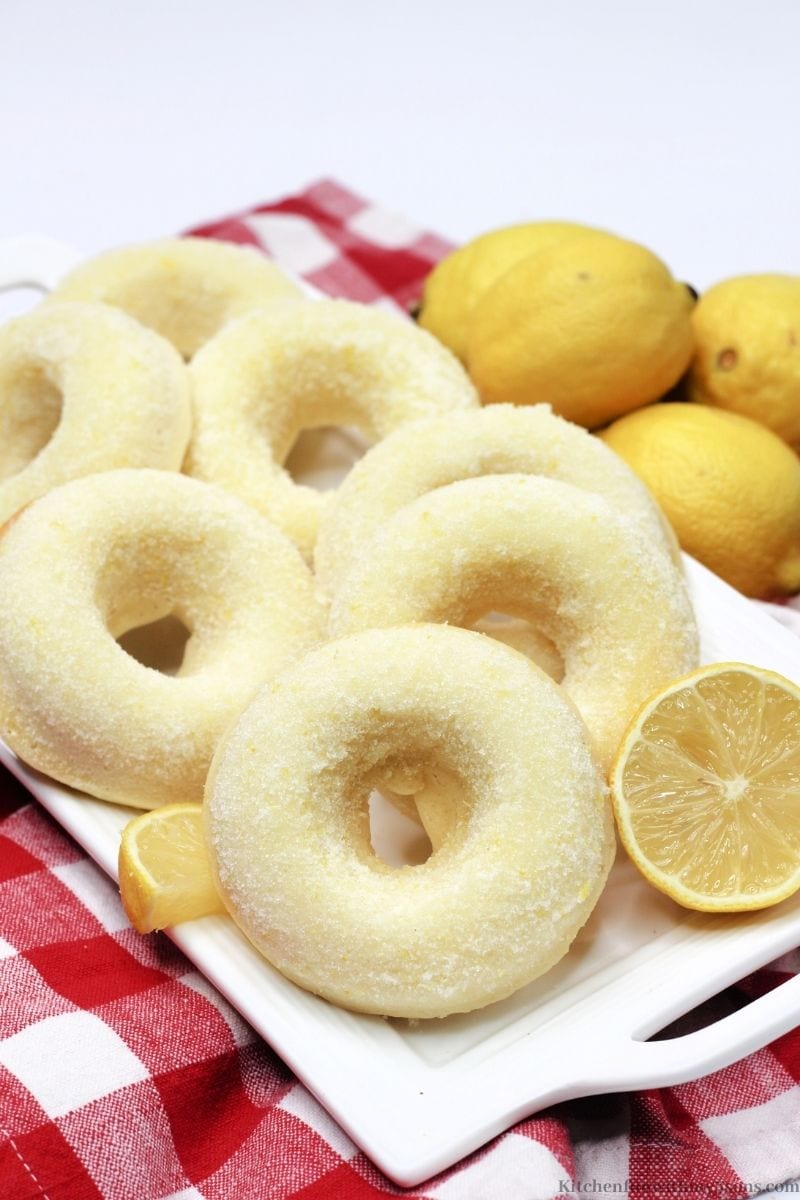 Sugared Lemon Donuts on a red and white checkered cloth.