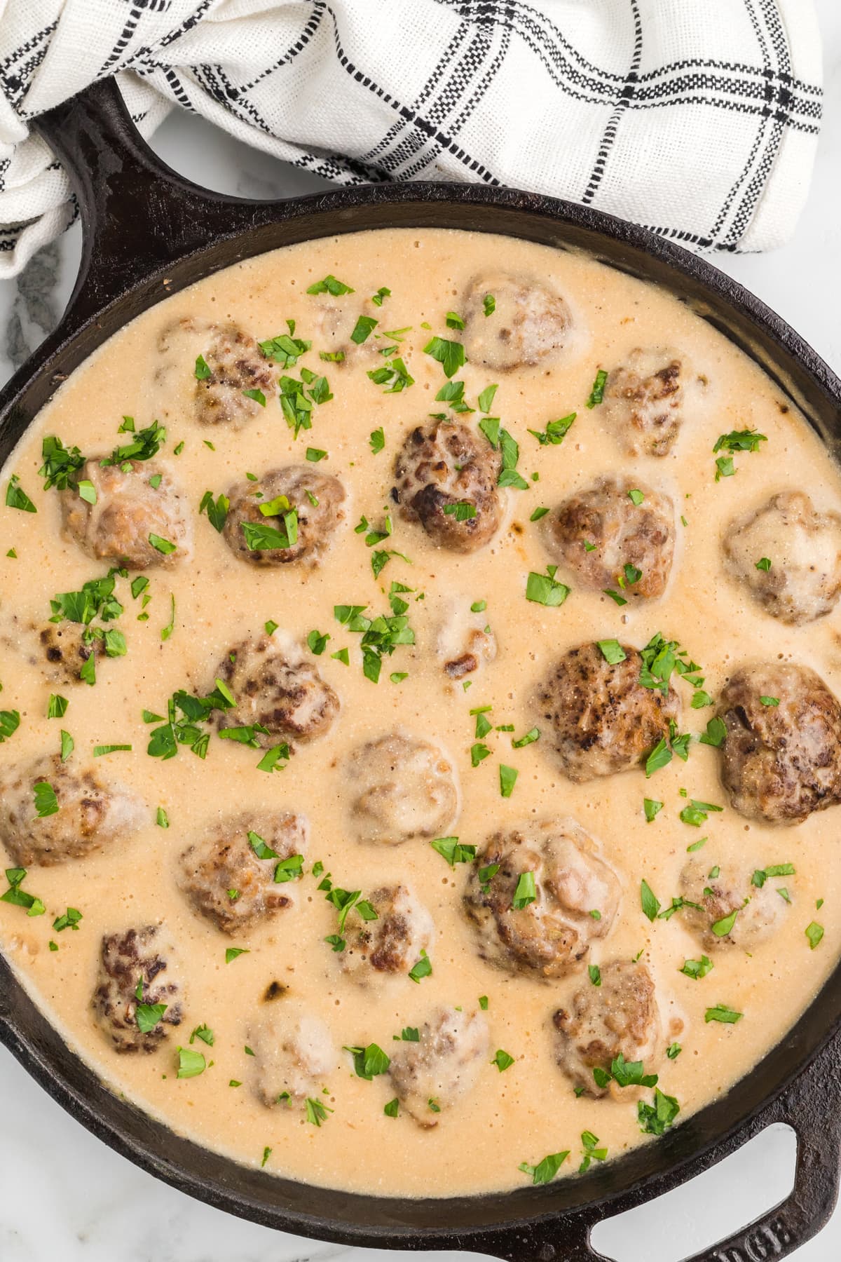 Ikea meatballs in a skillet topped with parsley