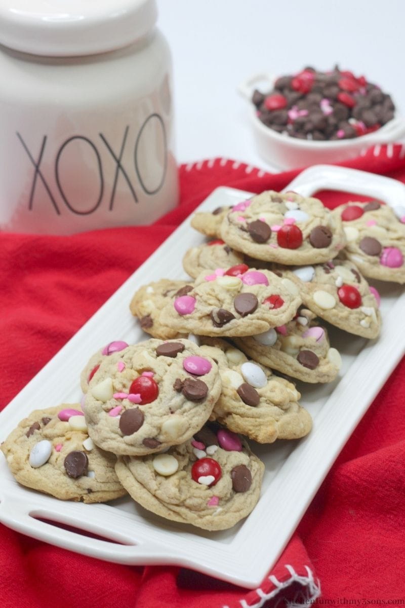 Valentine's Day Chocolate Chip Cookies with a cookie jar behind it.