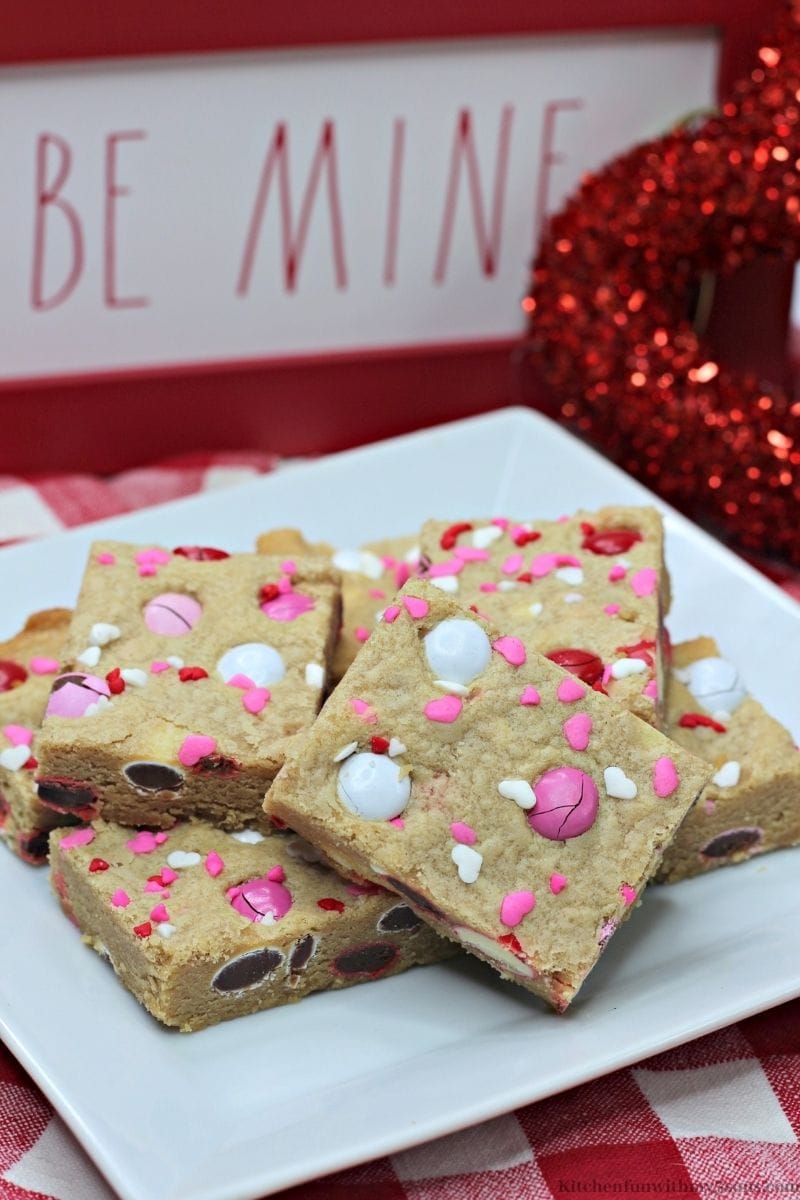 Valentine's Day Peanut Butter Cookie Bars on a white and red checkered cloth.