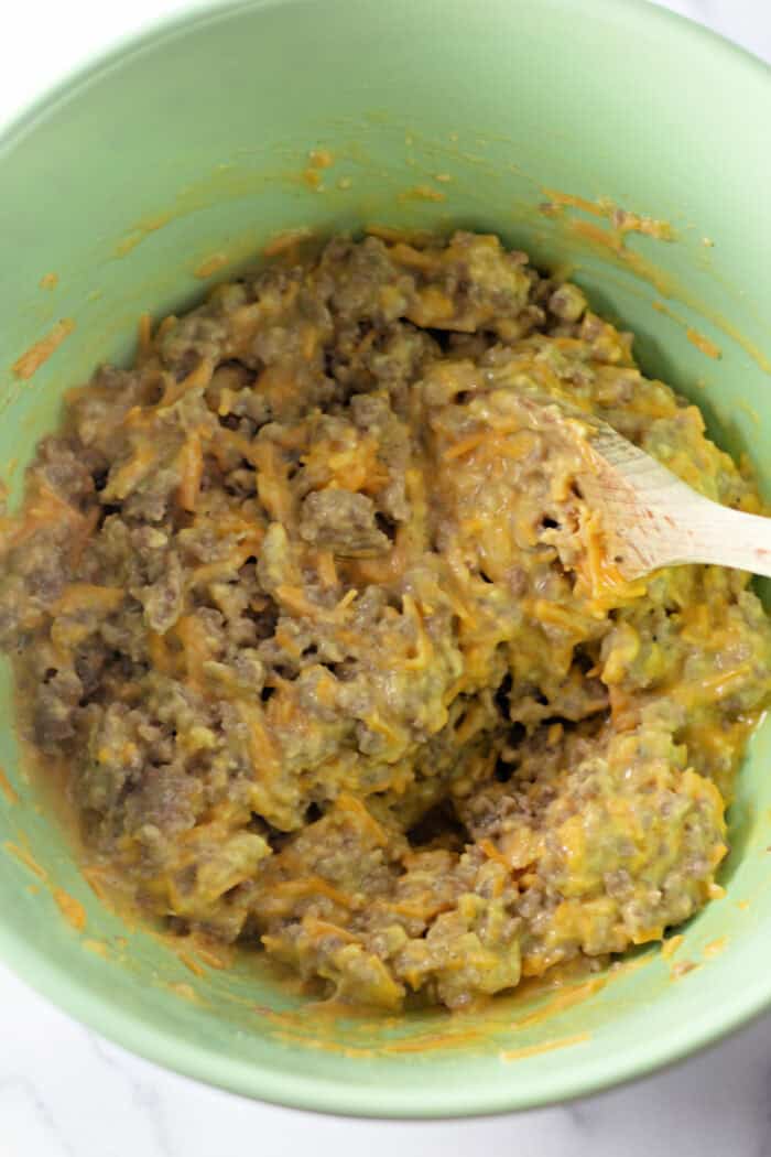 These easy Sausage Breakfast Muffins are packed with savory sausage, fluffy eggs, melted cheddar cheese, and Bisquick for the ultimate grab-and-go breakfast. mixing the muffin batter in a bowl