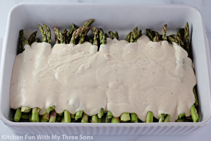 pouring cream sauce over the asparagus. 