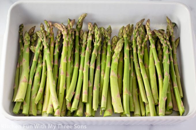 asparagus in a white baking dish.