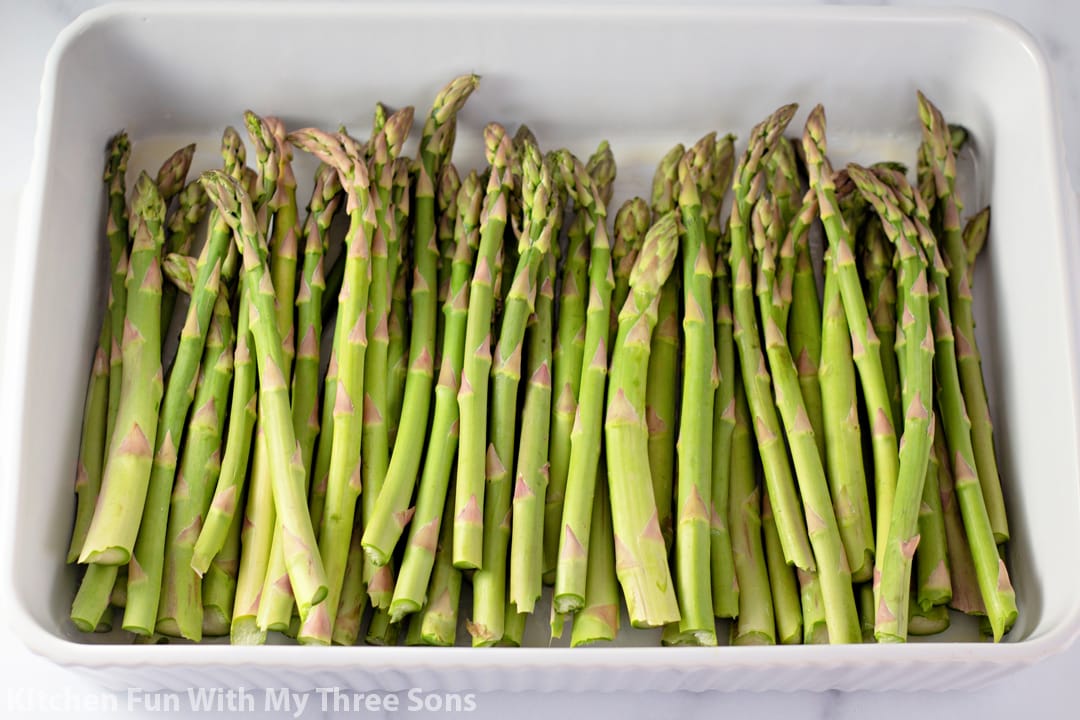 asparagus in a white baking dish.