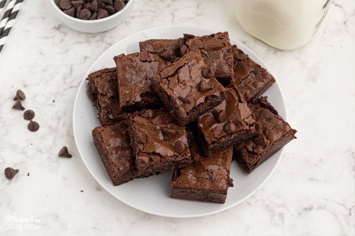 Overhead view of fudgy brownies on a white plate