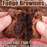 A hand breaking a fudge brownie into two