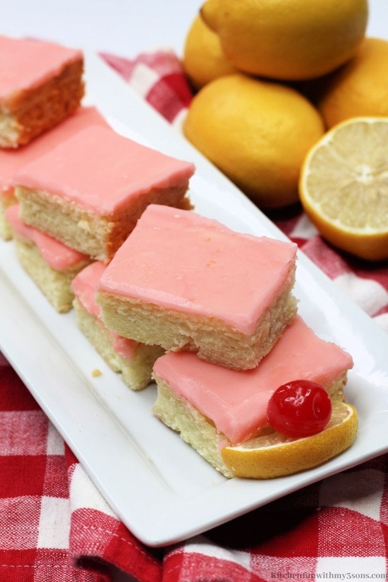 Cherry Lemonade Bars with a bunch of lemons next to it.