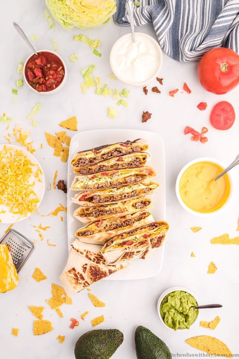 A row of crunchwraps cut in half to reveal the taco layers.