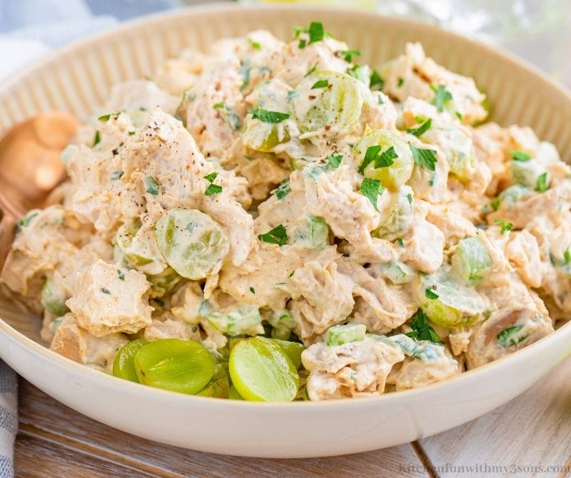 The Chicken Salad with Grapes in a large serving bowl with a wooden spoon.