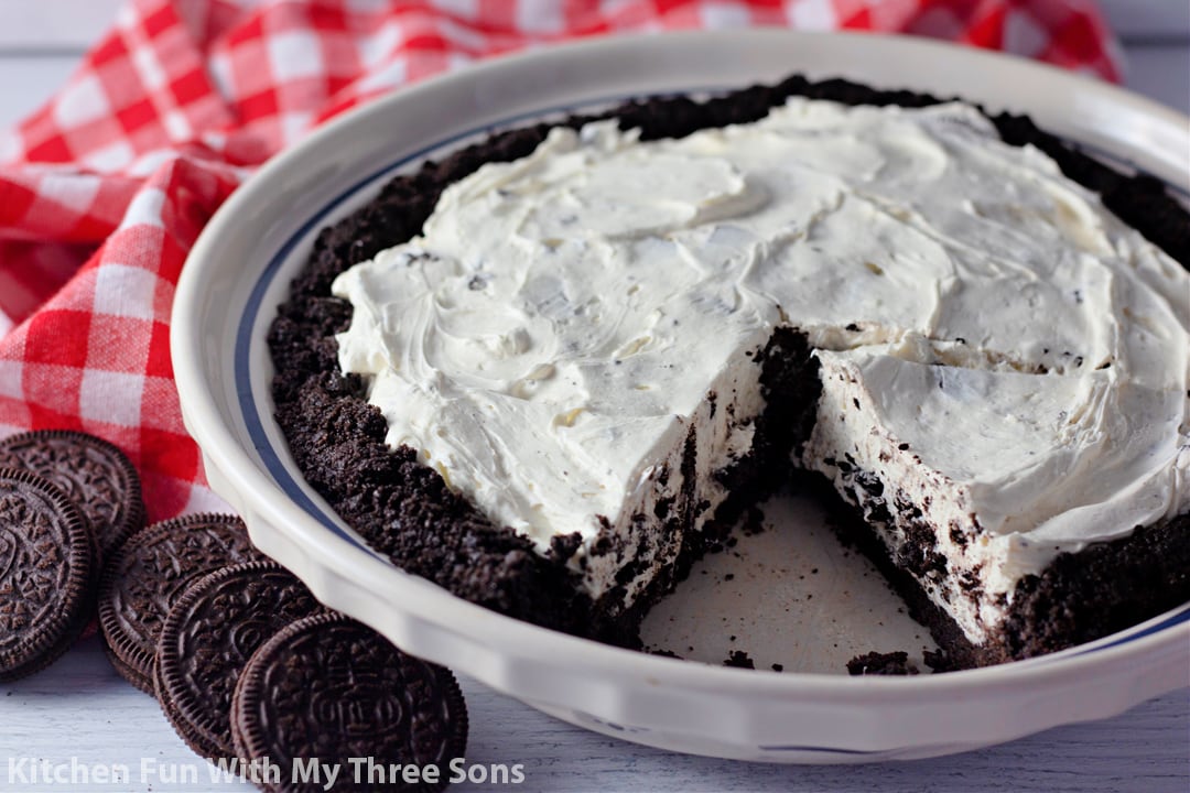 No-bake Oreo pie in a pie plate with a slice missing.