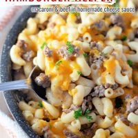 Ground beef pasta with cheddar cheese inside of a large skillet