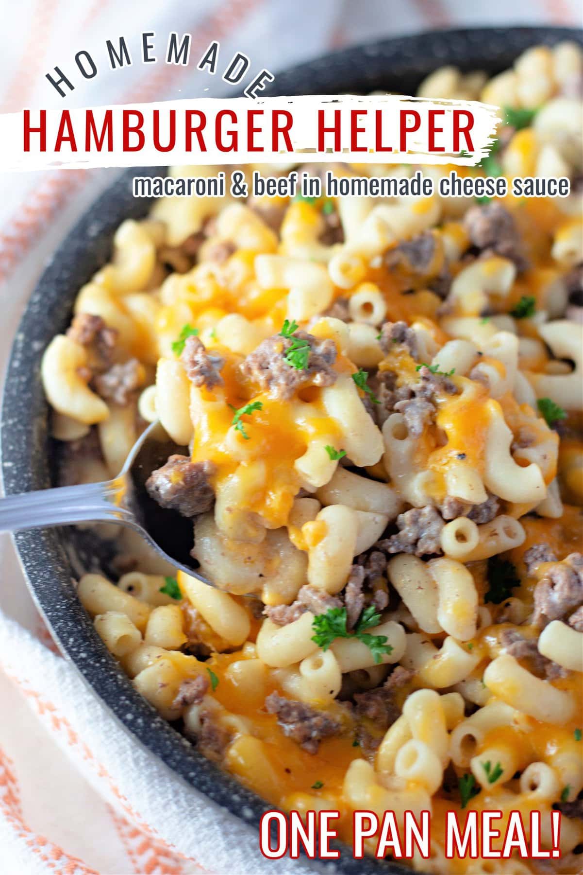 Ground beef pasta with cheddar cheese inside of a large skillet