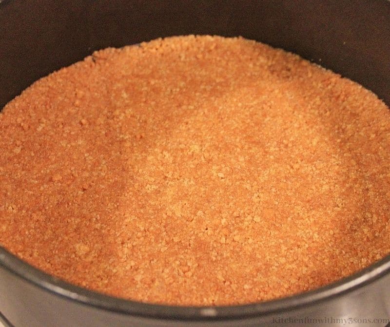 The graham cracker crust pressed into the pan.