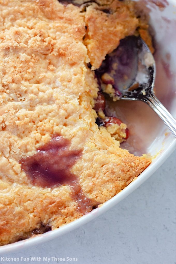 scooping Pineapple Cherry Dump Cake with a fork.