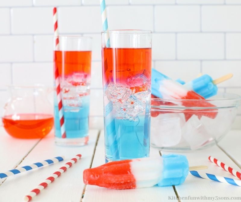 Rocket Pop Vodka Cocktail with a bowl of popsicles behind it.