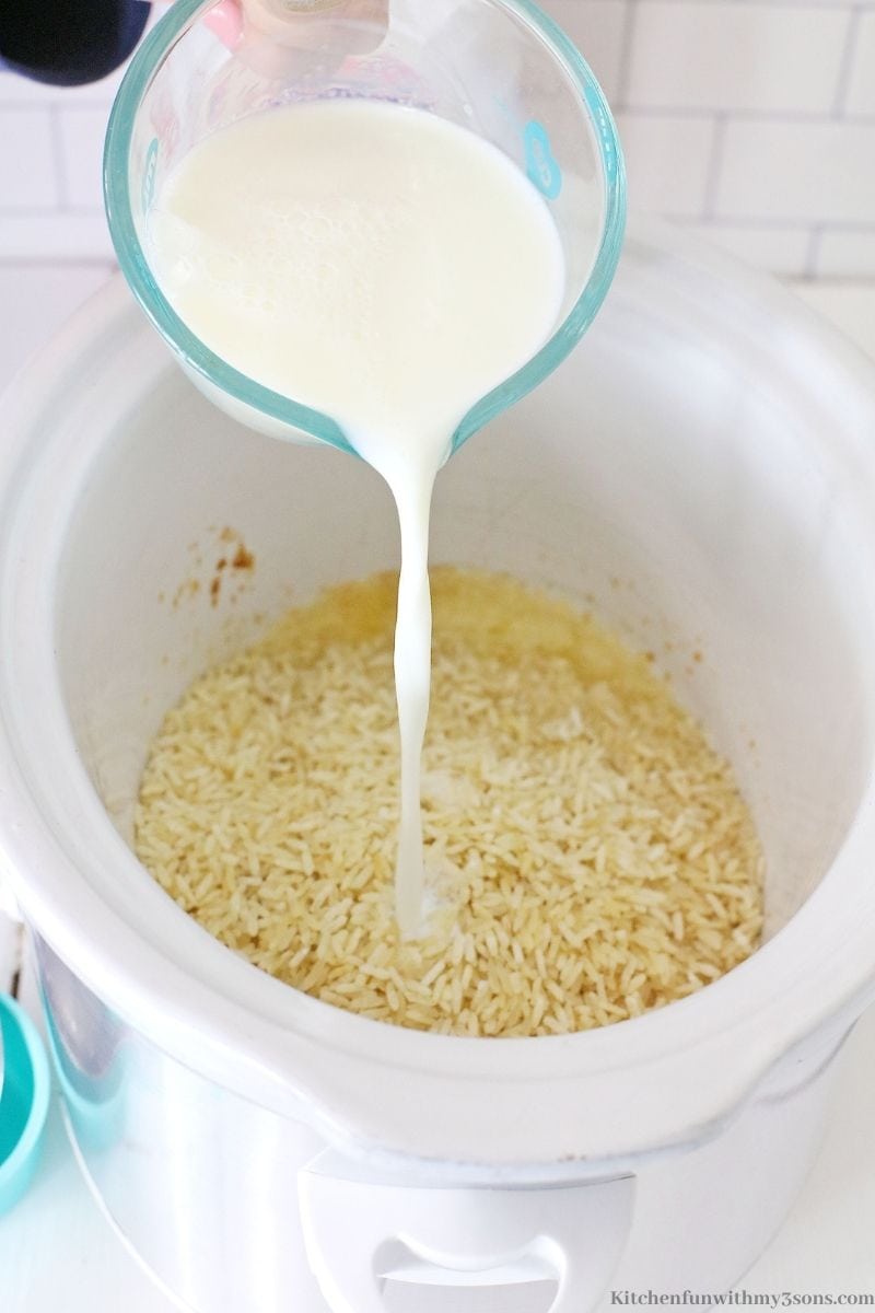 Pouring the milk into the butter covered rice.