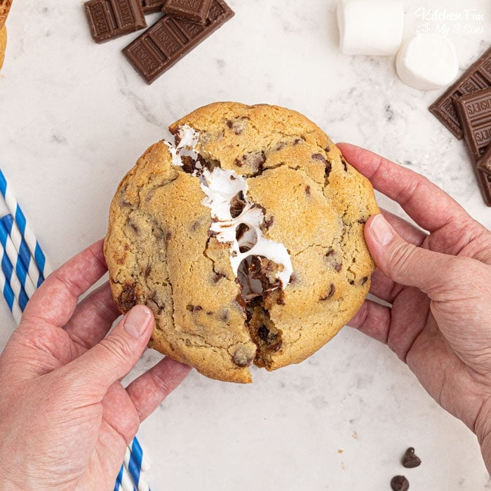 Smores Stuffed Cookies are a sandwich of homemade chocolate chip cookies with graham crackers, marshmallows and Hershey's chocolate stuffed inside.
