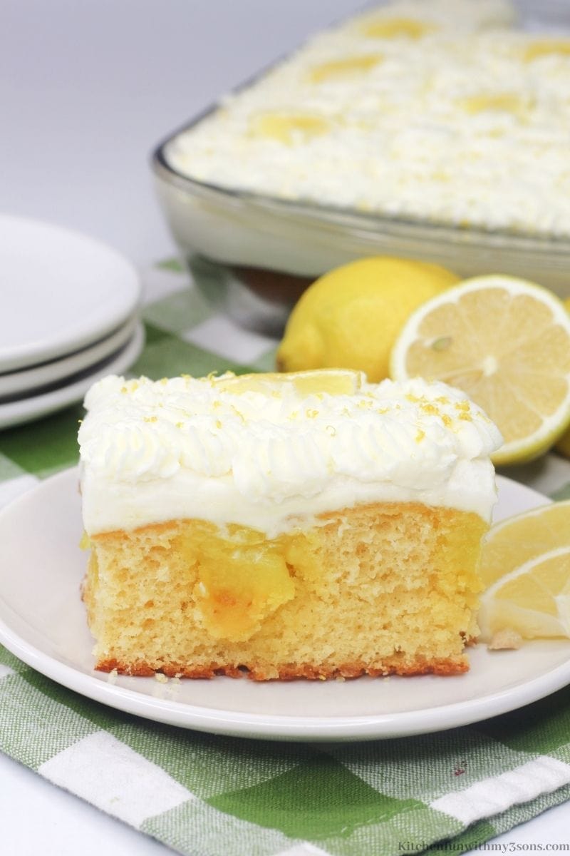 A piece of the lemon cake with some lemon slices.