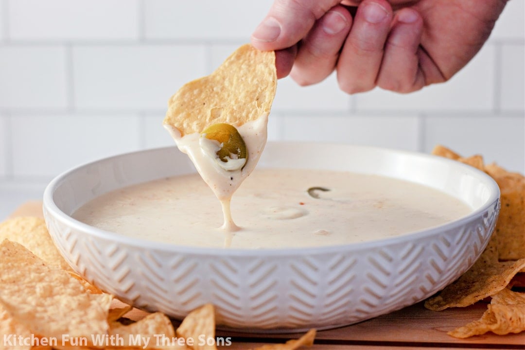 White Queso Dip in a bowl with a tortilla chip