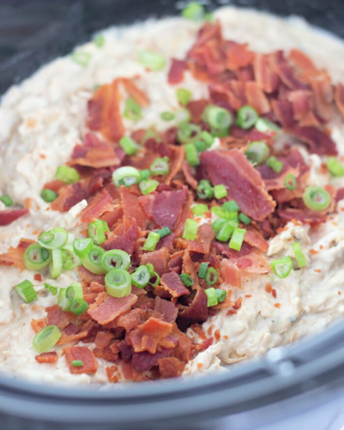 crumbled bacon over crack chicken in the slow cooker